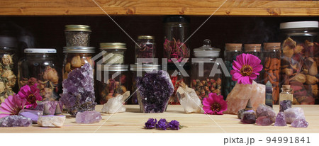 Amethyst Crystals and Flowers On Meditation Table 94991841