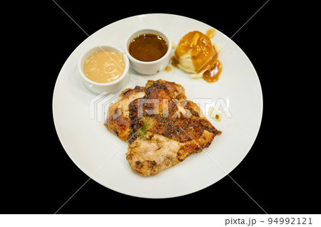 Top view of Chicken Steak with Black Pepper on a white plate, focus selective Top view of Chicken Steak with Black Pepper on a white plate, focus selective 94992121