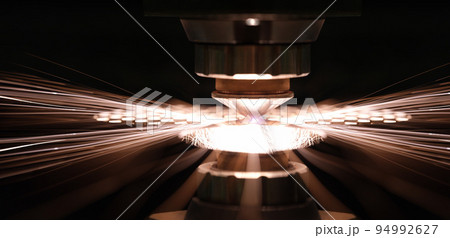 Laser cutting of metal sheet in production closeup 94992627