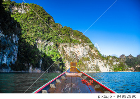 Long Tail boat on Khao Sok national park Cheow Lan Dam lake in Surat Thani, Thailand Long Tail boat on Khao Sok national park Cheow Lan Dam lake in Surat Thani, Thailand 94992990