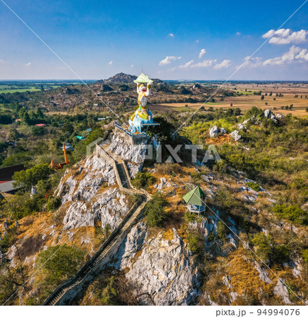 Aerial view of Wat Khao Samo Khon temple, with hanuman monkey god statue on top of mountain, in 94994076