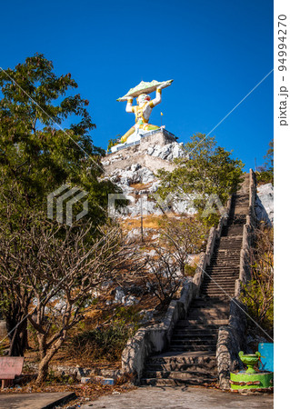 Aerial view of Wat Khao Samo Khon temple, with hanuman monkey god statue on top of mountain, in 94994270
