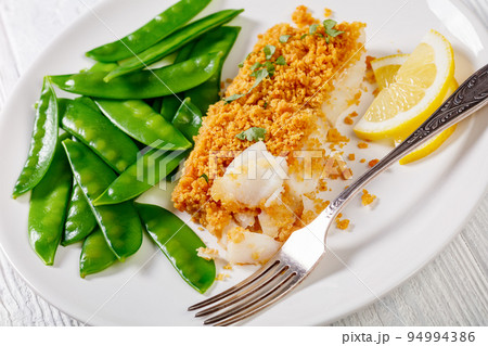 Baked Cod with Crackers toppings and snow peas Baked Cod with Crackers toppings and snow peas 94994386