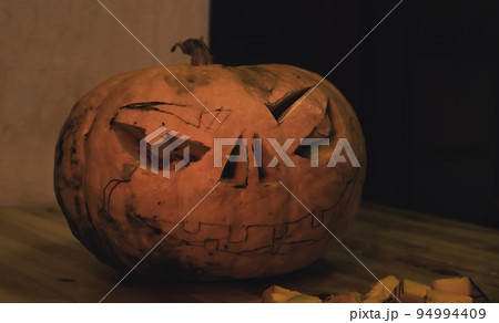 preparation for the holiday. The process of carving a Halloween pumpkin on the table preparation for the holiday. The process of carving a Halloween pumpkin on the table 94994409