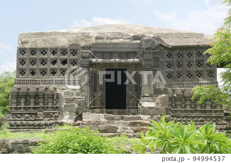 Carved outer wall of the Laxminarayana temple one of the five rock temples inside Bahadurgad, Pedgaon, Taluka Shrigonda, Maharashtra, India 94994537