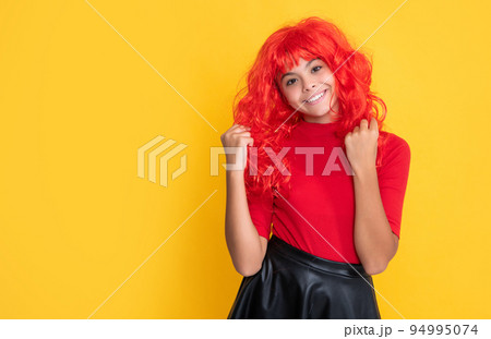 glad child with red long hair on yellow background glad child with red long hair on yellow background 94995074