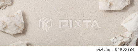 Natural cosmetic background for product presentation. White rocks on the sand. Top view. 94995234