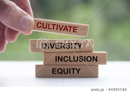 Hand holding wooden block with text - Cultivate diversity, inclusion and equity. Business culture concept 94995580