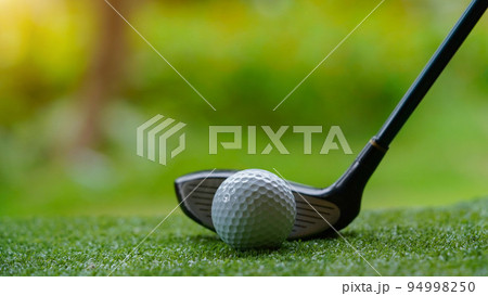 Golf club and ball in grass concept. Golf balls on the golf course with golf clubs. Golf club and ball in grass concept. Golf balls on the golf course with golf clubs. 94998250