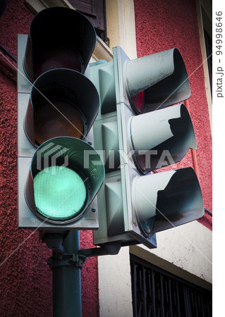 Green go light on traffic light on street corner Green go light on traffic light on street corner 94998646