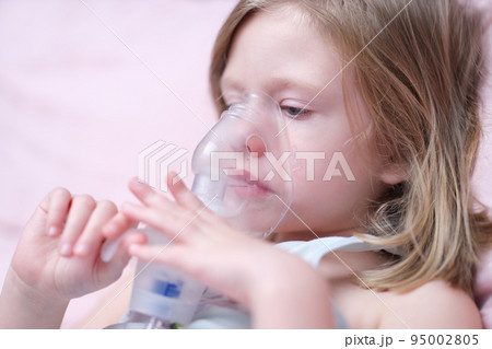 Portrait of child girl with inhaler for asthma 95002805