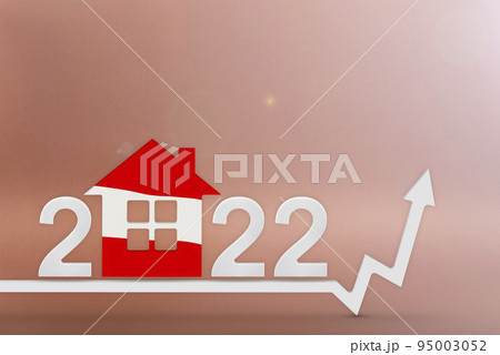 The cost of real estate in Austria in 2022. Rising cost of construction, insurance, rent in Austria. House model painted in flag colors, up arrow on red background 95003052