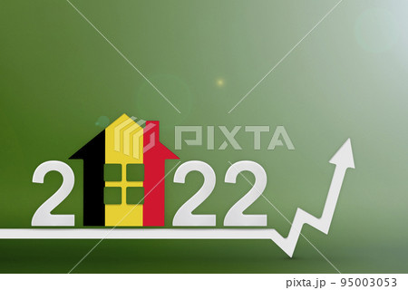 The cost of real estate in Belgium in 2022. Rising cost of construction, insurance, rent in Belgium. House model painted in the colors of the flag, up arrow on a green background 95003053