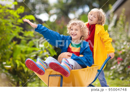 Kids on pumpkin patch. Child autumn outdoor fun. 95004748