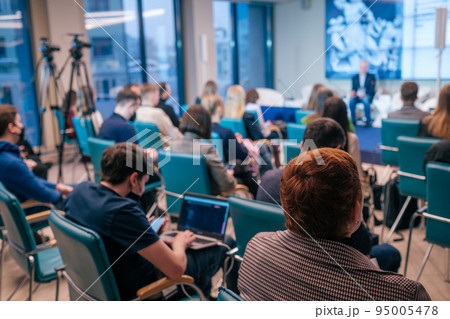 Businesspeople watching presentation in evening Businesspeople watching presentation in evening 95005478