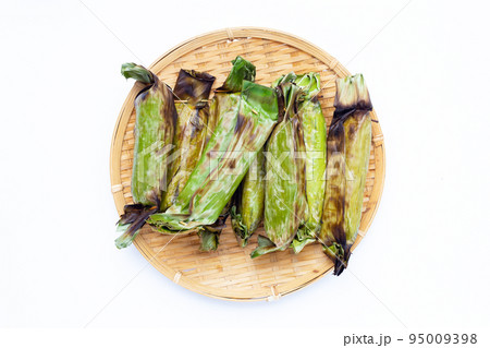 Grilled sticky rice in banana leaves with banana filling 95009398