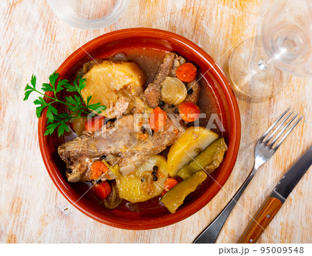 Ribs with vegetables prepared and served on plate Ribs with vegetables prepared and served on plate 95009548