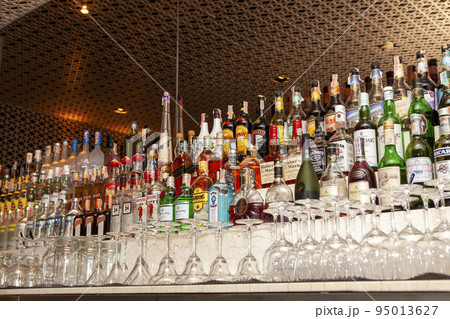 Various alcohol bottles in a bar, back light, all logos removed 95013627
