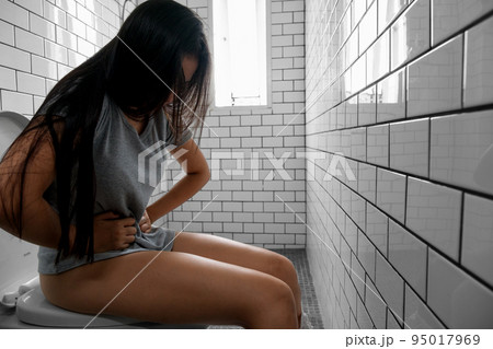 Young woman sitting on toilet and stomach ache. Young woman sitting on toilet and stomach ache. 95017969