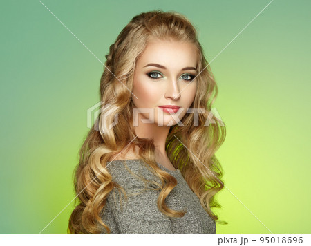 Blonde girl with long and shiny curly hair Blonde girl with long and shiny curly hair 95018696