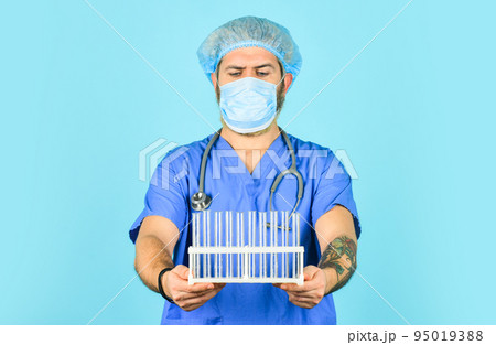 outbreak of new coronavirus. first signs of virus. virus transmission method. incubation period. man doctor in mask hold tubes for test. Chinese virus infection risks. disease control and prevention 95019388