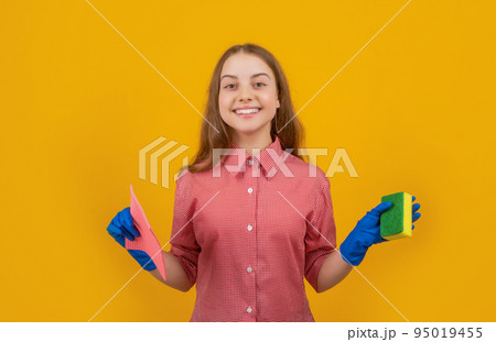 happy cheerful child in rubber gloves with sponge on yellow background happy cheerful child in rubber gloves with sponge on yellow background 95019455
