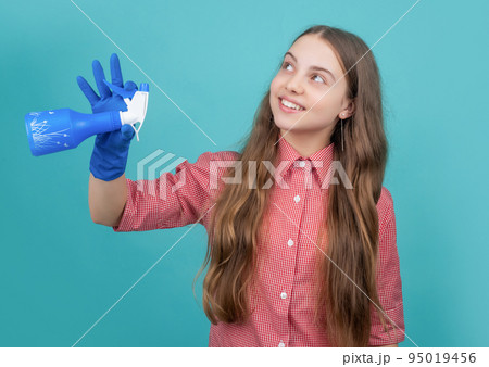 smiling child in rubber gloves with spray bottle on blue background smiling child in rubber gloves with spray bottle on blue background 95019456
