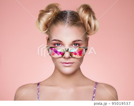 Portrait of beautiful young woman with colored glasses 95019537
