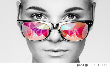 Portrait of beautiful young woman with colored glasses 95019538