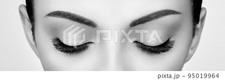 Female eye with long false eyelashes 95019964