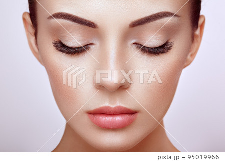 Beautiful woman with long false eyelashes 95019966