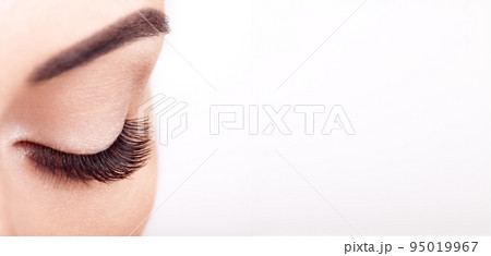 Female eye with long false eyelashes 95019967
