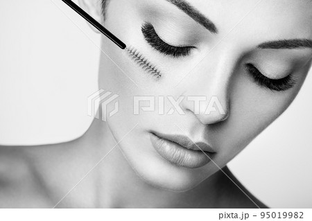 Beautiful woman with long false eyelashes 95019982