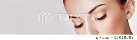 Beautiful woman with long false eyelashes 95019985