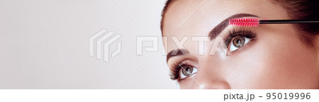 Beautiful woman with long false eyelashes Beautiful woman with long false eyelashes 95019996