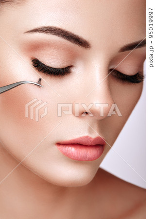 Beautiful woman with long false eyelashes Beautiful woman with long false eyelashes 95019997