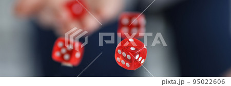 Red dice flying over casino chips closeup Red dice flying over casino chips closeup 95022606
