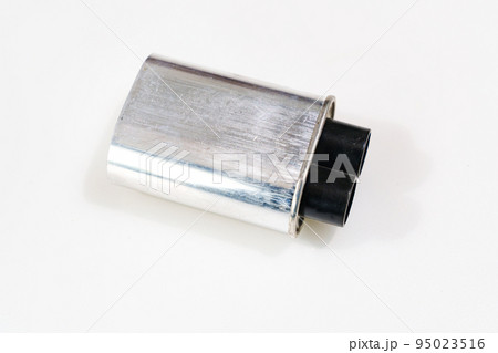 High-voltage capacitor on a white background. Part of microwave oven  95023516