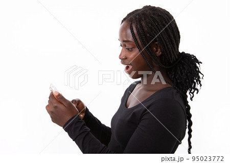 Portrait of excited young woman reading message on mobile phone 95023772