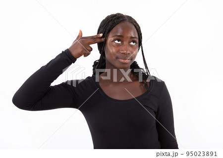 Portrait of smiling young woman making suicide gesture Portrait of smiling young woman making suicide gesture 95023891