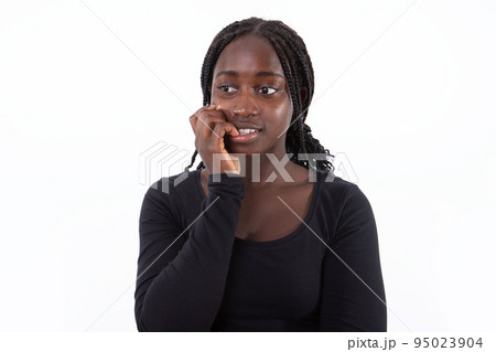 Portrait of neuritoc young woman biting nails 95023904