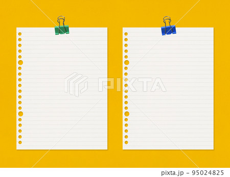 Empty note paper with clip on yellow art paper background. 95024825