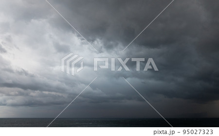 Dramatic dark stormy sky over sea water, natural photo 95027323