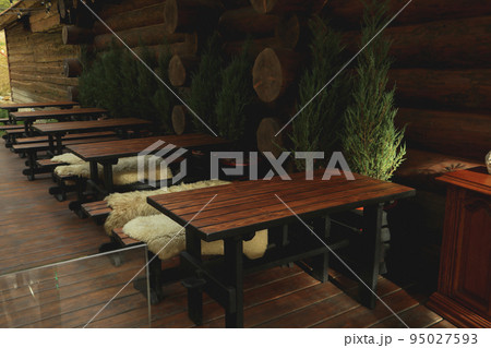 Cozy restaurant with outdoor tables in mountain resort Cozy restaurant with outdoor tables in mountain resort 95027593