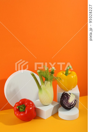 Vegetables on pedestals on two tone background 95028227
