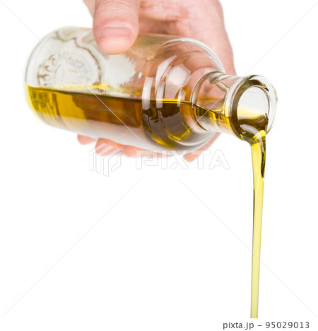 Oil pouring from a bottle. 95029013