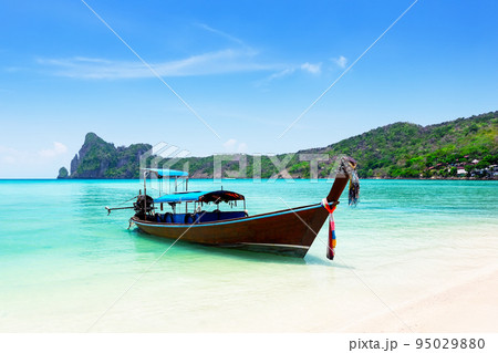 Thai traditional wooden longtail boat and beautiful sand beach at Koh Phi Phi island in Krabi province in Thailand. 95029880