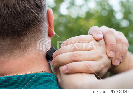 The criminal hits the man in the neck with a stun gun The criminal hits the man in the neck with a stun gun 95030845