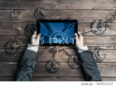 Business workplace with tablet device in female hands and media user interface 95031247