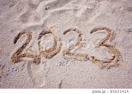 New Year 2023. Figures on the sandy shell seashore New Year 2023. Figures on the sandy shell seashore 95031414